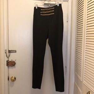 Black pants with gold trim accents